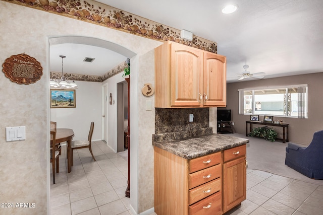 kitchen with ceiling fan, backsplash, light tile floors, and pendant lighting