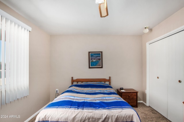 bedroom with a closet and light carpet