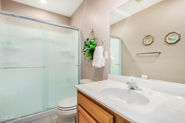 bathroom featuring a shower with shower door, oversized vanity, toilet, and tile floors