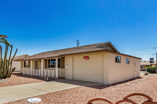 single story home with a porch and a garage