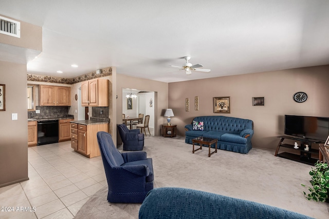 tiled living room with ceiling fan with notable chandelier