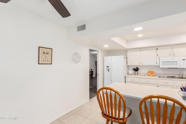 kitchen with recessed lighting, light countertops, visible vents, light tile patterned flooring, and white appliances