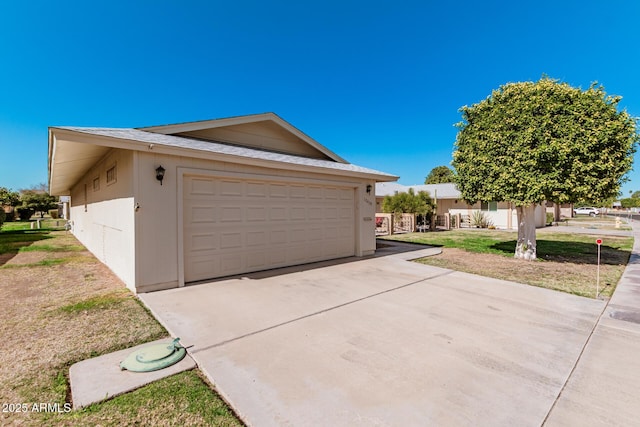 view of property exterior featuring a garage and a lawn