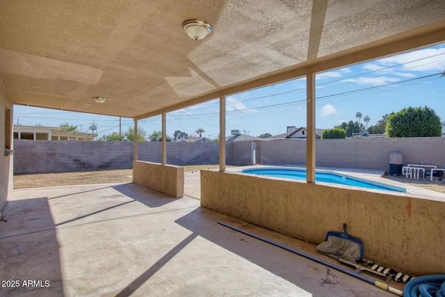 view of patio / terrace with a fenced in pool