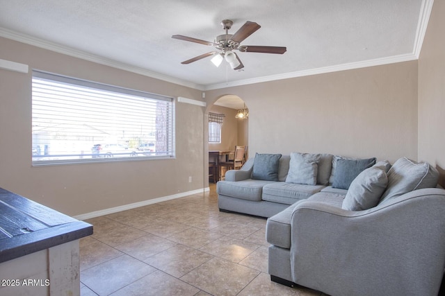 living room featuring light tile patterned floors, ceiling fan, and crown molding