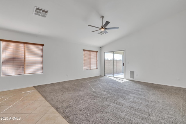 tiled empty room featuring lofted ceiling and ceiling fan