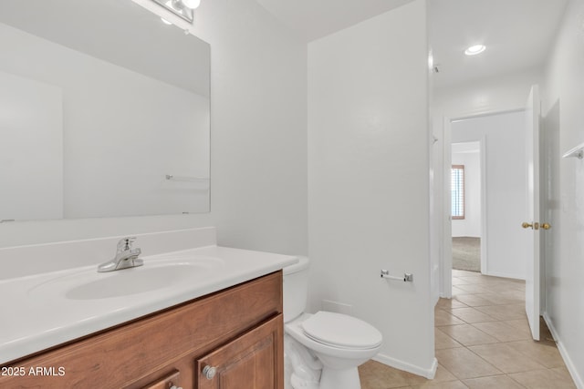 bathroom featuring tile patterned flooring, vanity, and toilet