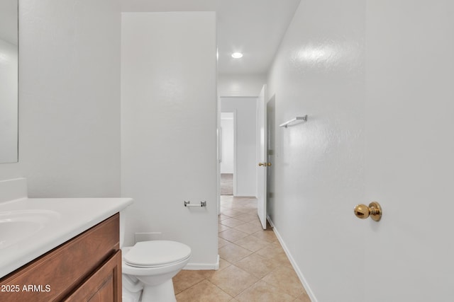 bathroom with tile patterned flooring, vanity, and toilet