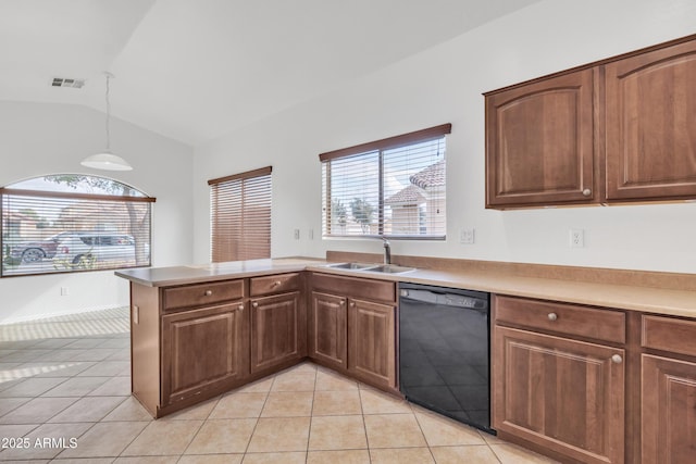 kitchen featuring vaulted ceiling, dishwasher, sink, hanging light fixtures, and kitchen peninsula