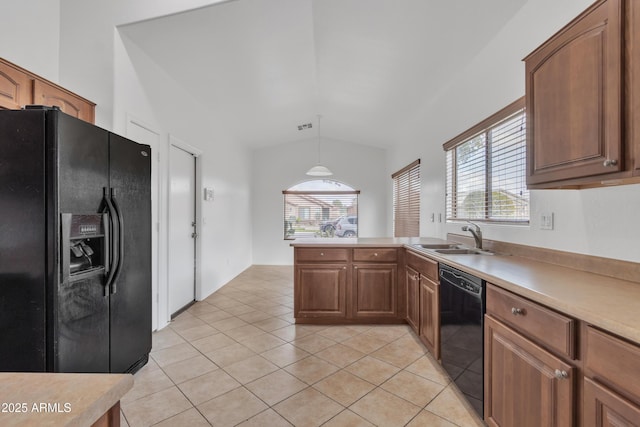 kitchen with vaulted ceiling, sink, hanging light fixtures, black appliances, and a healthy amount of sunlight