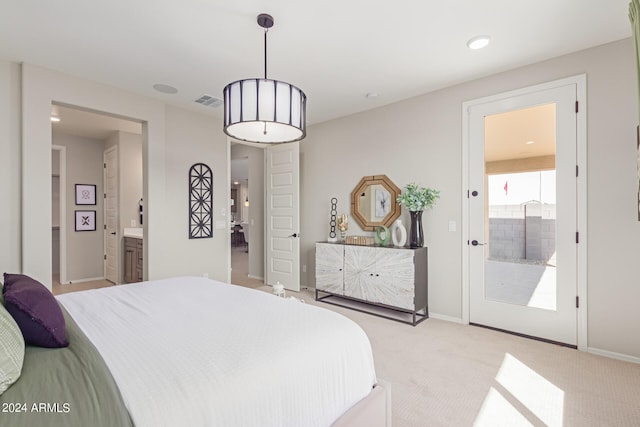 carpeted bedroom featuring baseboards, visible vents, and ensuite bath