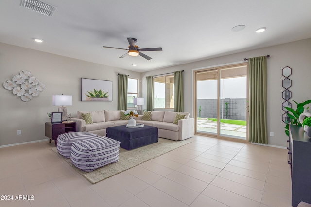 living area featuring light tile patterned floors, baseboards, visible vents, a ceiling fan, and recessed lighting