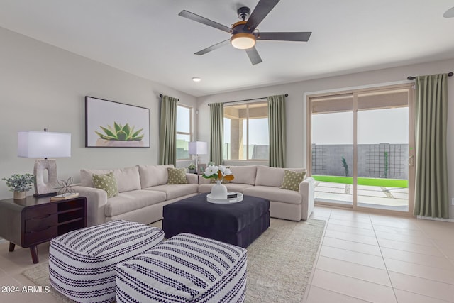 living area featuring ceiling fan and light tile patterned floors