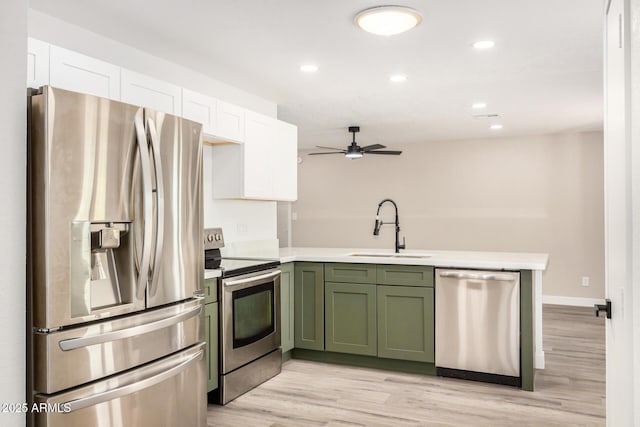 308 W Oraibi Dr, Phoenix, AZ 85027 - kitchen with appliances with stainless steel finishes, green cabinetry, white cabinets, a ceiling fan, and a peninsula