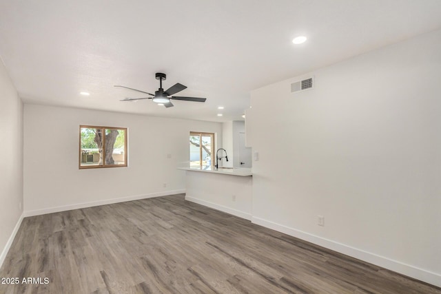 308 W Oraibi Dr, Phoenix, AZ 85027 - unfurnished living room with ceiling fan, wood finished floors, and recessed lighting