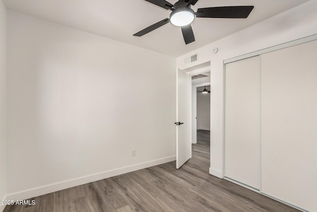 308 W Oraibi Dr, Phoenix, AZ 85027 - unfurnished bedroom with wood finished floors, a closet, and a ceiling fan