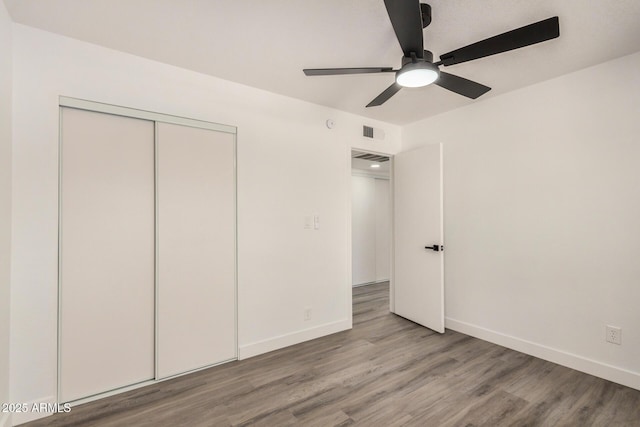 308 W Oraibi Dr, Phoenix, AZ 85027 - unfurnished bedroom featuring wood finished floors, a closet, and ceiling fan