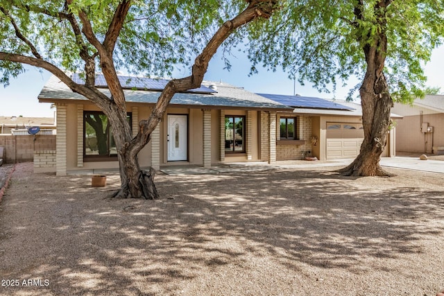 308 W Oraibi Dr, Phoenix, AZ 85027 - single story home featuring an attached garage, solar panels, and concrete driveway
