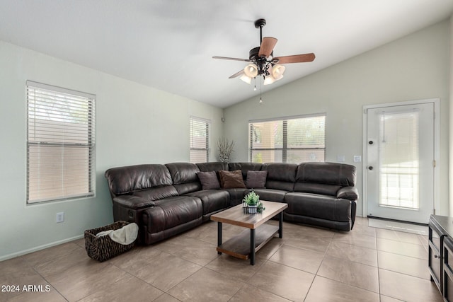 tiled living room with ceiling fan and lofted ceiling