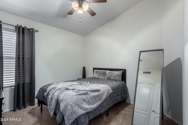 bedroom with tile patterned flooring, vaulted ceiling, and ceiling fan