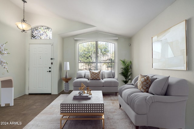 tiled living room featuring a healthy amount of sunlight and lofted ceiling