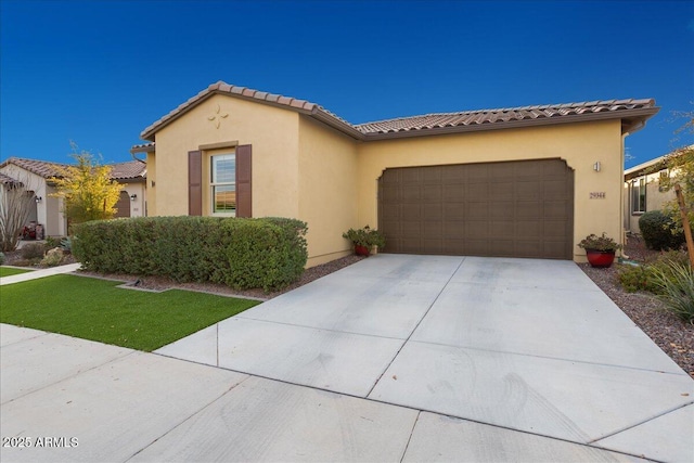 29344 N 132nd Ln, Peoria, AZ 85383 - mediterranean / spanish-style home featuring a garage, driveway, stucco siding, and a tiled roof