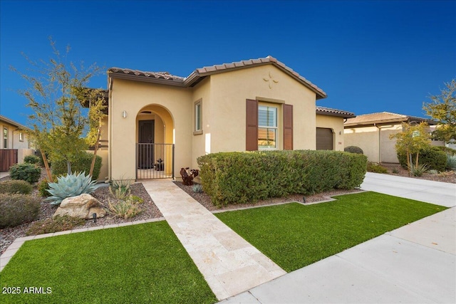 29344 N 132nd Ln, Peoria, AZ 85383 - mediterranean / spanish-style home with an attached garage, stucco siding, a tile roof, and a gate