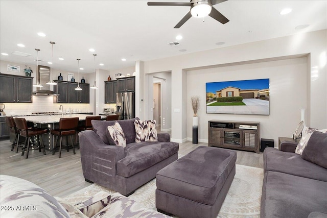 29344 N 132nd Ln, Peoria, AZ 85383 - living area featuring light wood-type flooring, a ceiling fan, recessed lighting, and baseboards