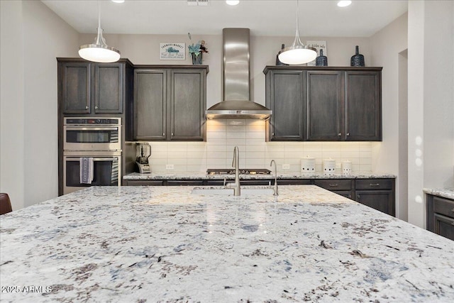 29344 N 132nd Ln, Peoria, AZ 85383 - kitchen featuring wall chimney range hood, stainless steel double oven, backsplash, light stone countertops, and pendant lighting