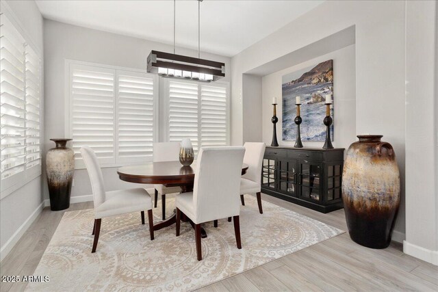 29344 N 132nd Ln, Peoria, AZ 85383 - dining room with wood finished floors, a chandelier, and baseboards