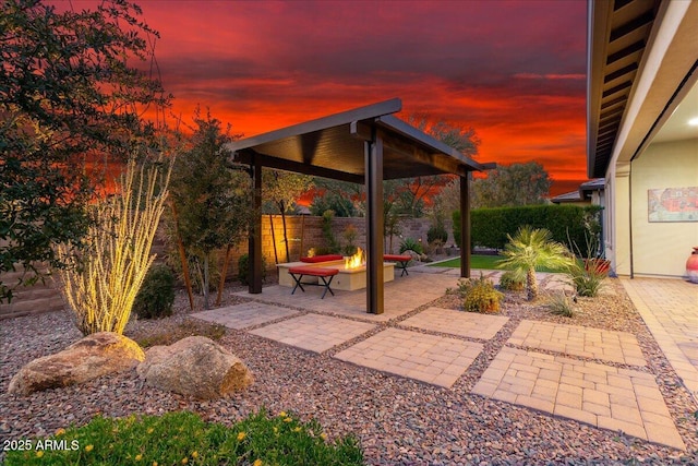 29344 N 132nd Ln, Peoria, AZ 85383 - patio terrace at dusk with an outdoor fire pit, a gazebo, and fence