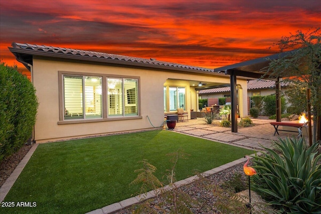 29344 N 132nd Ln, Peoria, AZ 85383 - rear view of house featuring stucco siding, a patio, a lawn, and a tile roof