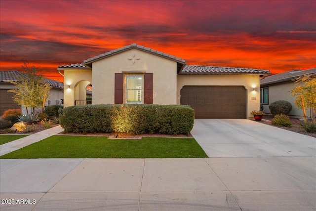 29344 N 132nd Ln, Peoria, AZ 85383 - mediterranean / spanish-style home with a tile roof, an attached garage, stucco siding, and concrete driveway