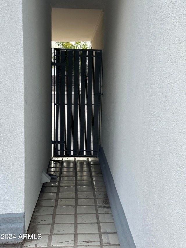 hallway with tile patterned flooring