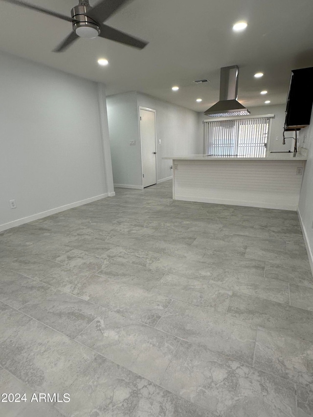 unfurnished living room featuring ceiling fan and light tile patterned floors