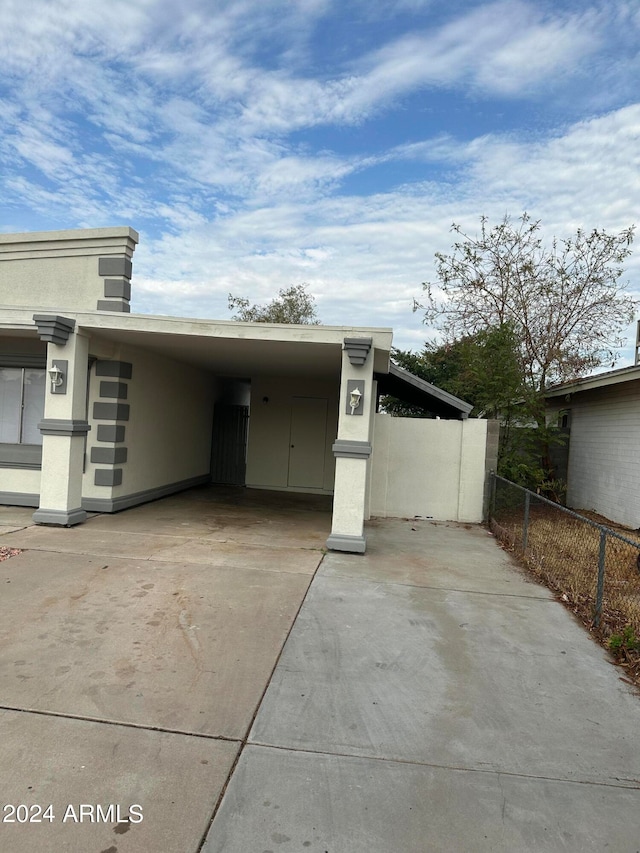 view of side of property with a carport