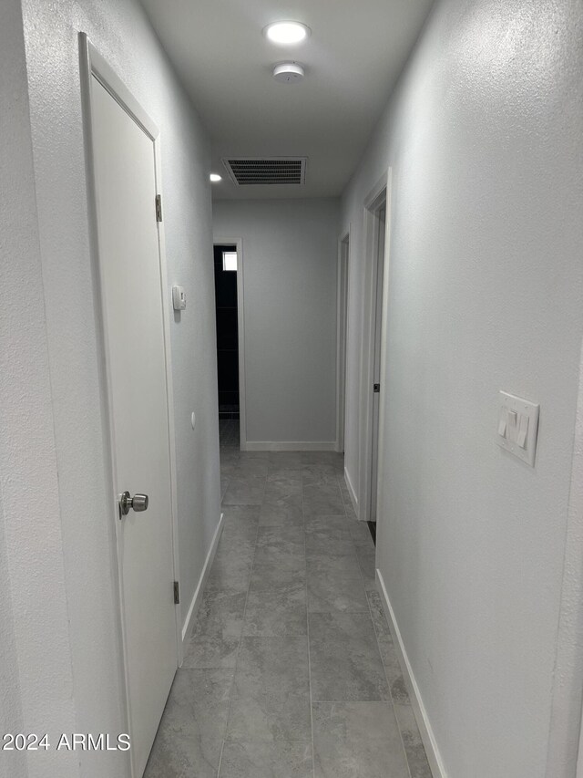 hallway featuring light tile patterned floors