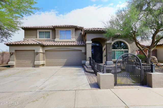 mediterranean / spanish-style house featuring stucco siding, concrete driveway, and a fenced front yard