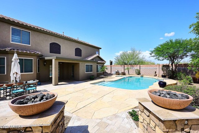 view of pool with a fenced backyard and a patio area
