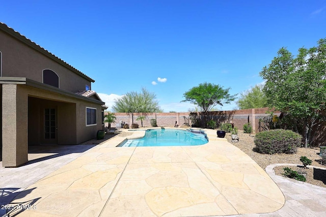 view of pool featuring a patio area and a fenced backyard