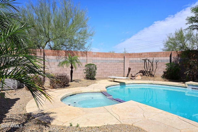 view of swimming pool with fence and a pool with connected hot tub