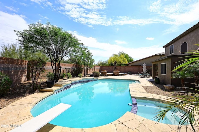 view of pool featuring a fenced backyard, a patio, and a pool with connected hot tub