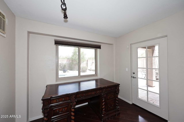 office area with plenty of natural light, dark wood finished floors, and baseboards