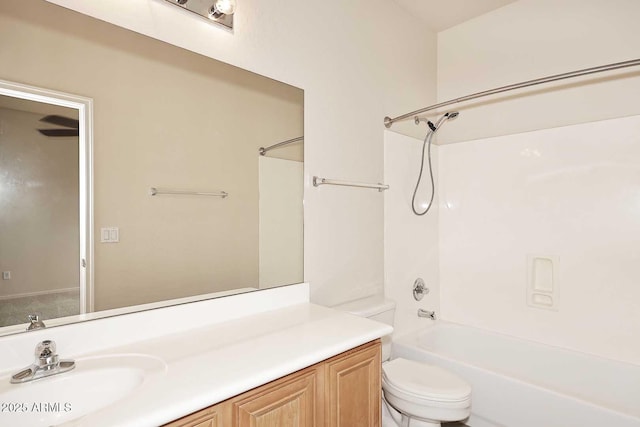 bathroom featuring toilet, vanity, and bathing tub / shower combination