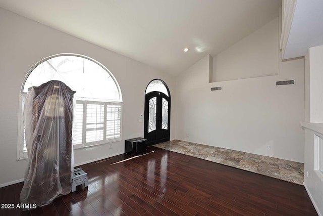 entrance foyer with lofted ceiling, wood finished floors, and baseboards