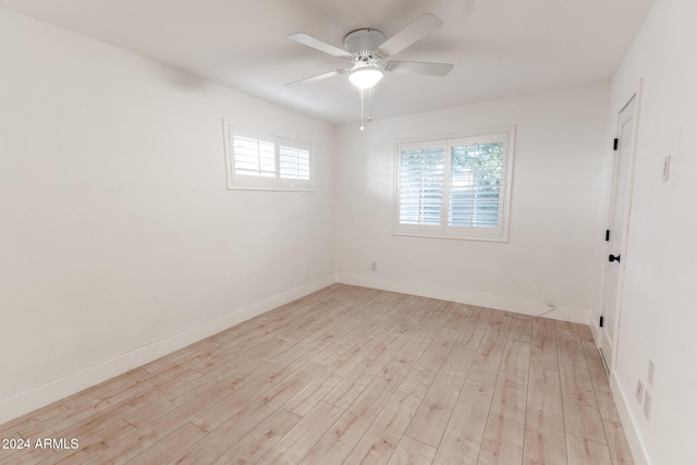 spare room featuring ceiling fan and light hardwood / wood-style floors