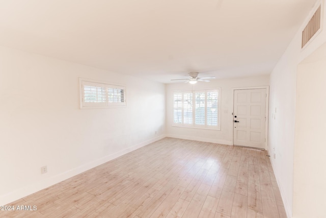 spare room featuring ceiling fan and light hardwood / wood-style floors