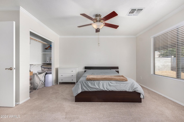 bedroom with crown molding, light colored carpet, a closet, and ceiling fan