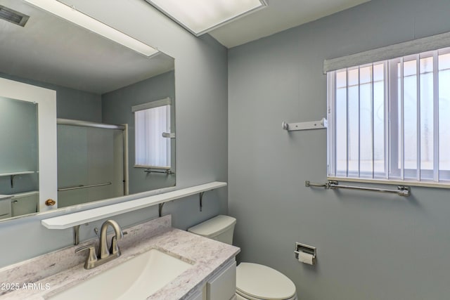 full bath with visible vents, vanity, toilet, and an enclosed shower