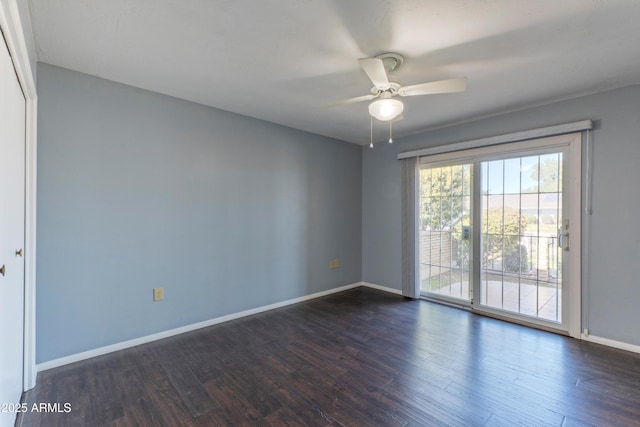 unfurnished room featuring ceiling fan, baseboards, and dark wood finished floors